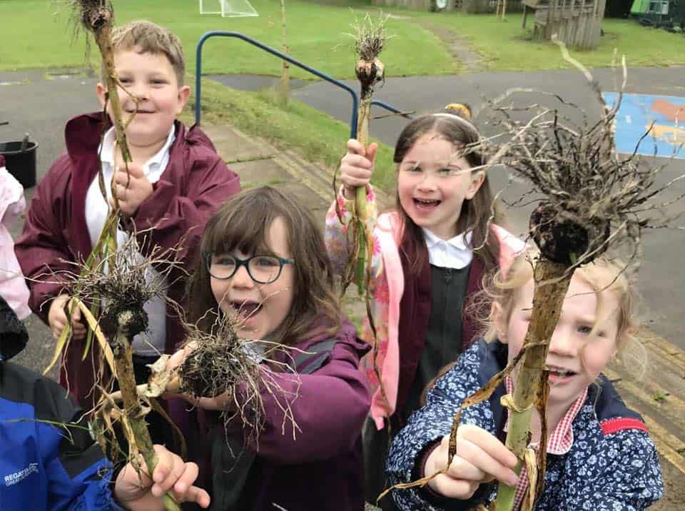 A group of children looking happy outdoors